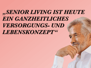 Älterer Mann mit grauem Bart in weißem Hemd, nachdenklich vor pinkem Hintergrund.